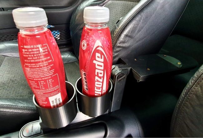 Dual cupholders with a padded armrest