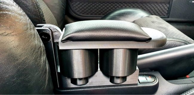 Black padded armrest with dual cupholder